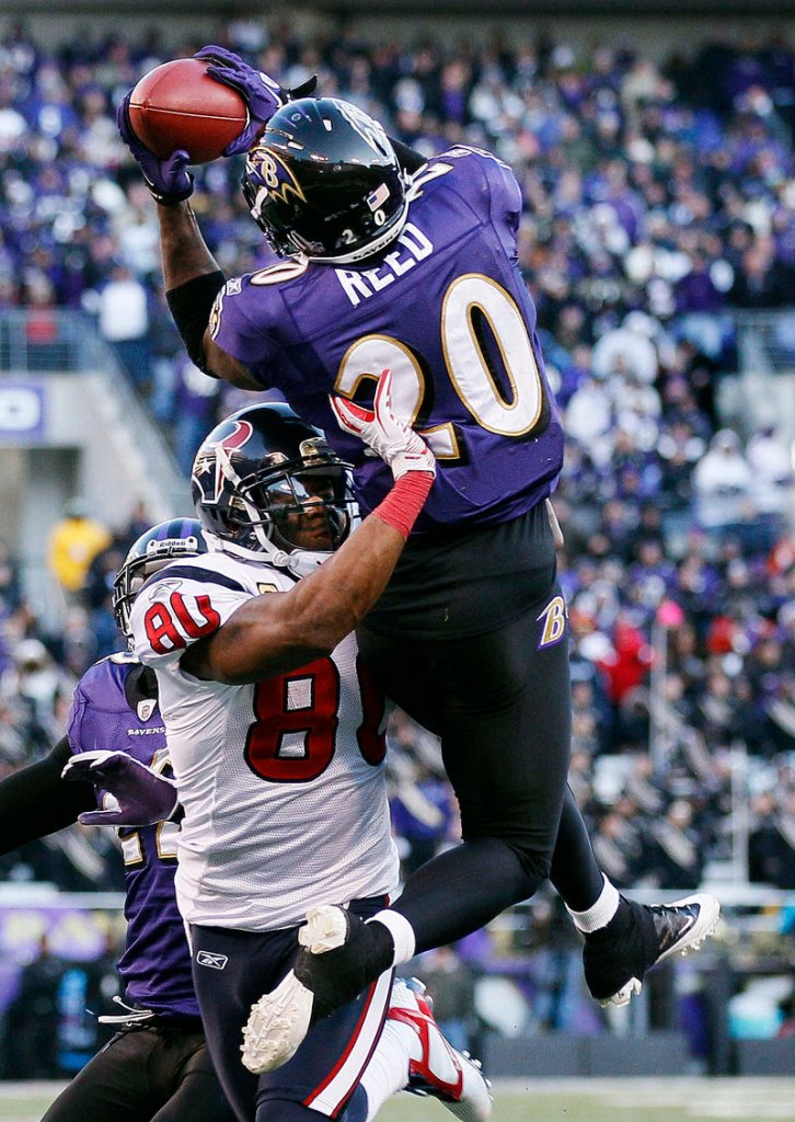 Ravens safety Ed Reed intercepts a pass intended for Andre Johnson late in the fourth quarter Sunday, helping Baltimore secure a 20-13 victory over the Houston Texans.