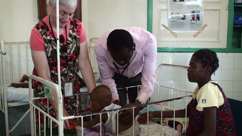 Dr. Ann Lemire of Portland, left, volunteer chair of Konbit Sante’s pediatric team, checks on a small patient with her colleague, Dr. Rony St. Fleur, during one of the group’s trips to Haiti.