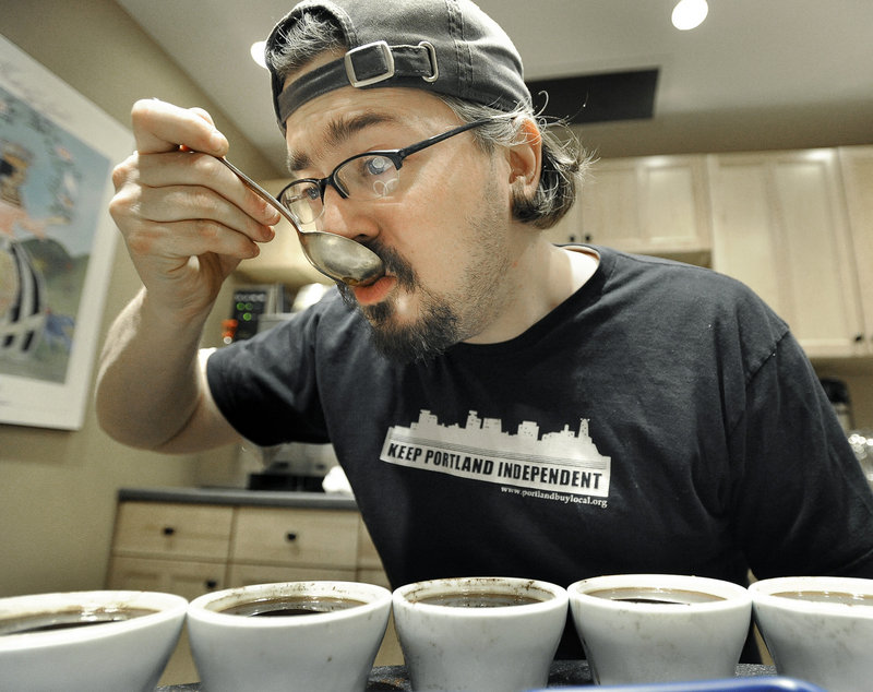 Dylan Hardman, head roaster at Coffee By Design, samples a coffee during a recent cupping demonstration.