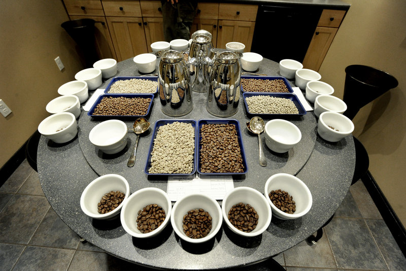 Set for a cupping, a table shows coffee beans prior to grinding.