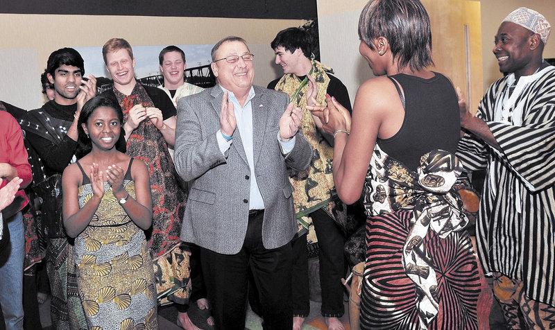 Gov. Paul LePage joins members of the Colby African Drumming Ensemble in a light moment Monday during a Martin Luther King Jr. breakfast in Waterville.
