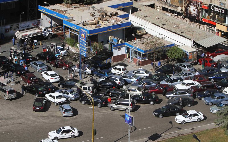 Egyptians wait in their cars at a gas station in Cairo, Egypt, on Monday. Rumors of increased prices have led to Egyptian citizens hoarding gasoline, possibly leading to shortages.