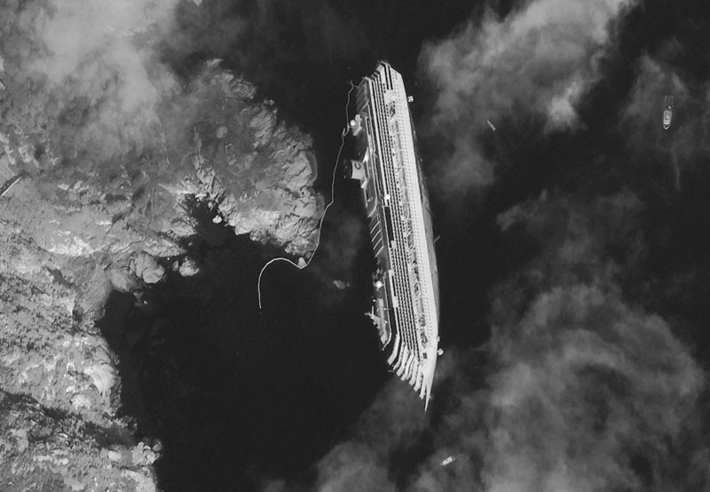 The luxury cruise ship Costa Concordia is seen in a satellite photo taken Tuesday just off the Tuscan island of Giglio, Italy. An official warned Wednesday of an environmental disaster if fuel leaks into the fragile ecosystem.