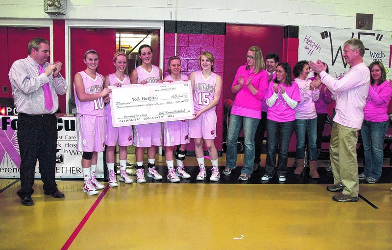 Lady Warriors presenting a check to York Hospital from their “Shootin’ for a Cure” campaign.