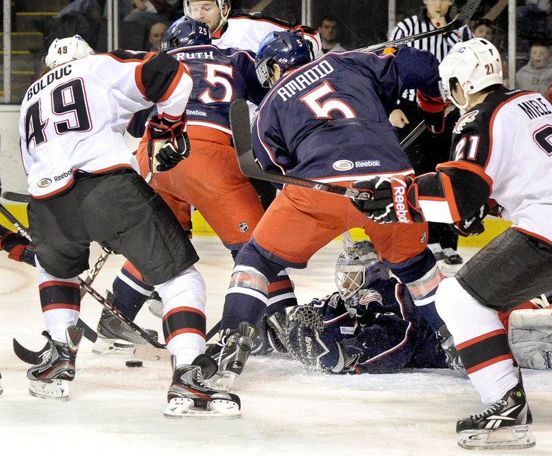Springfield Falcons goalie Manny Legace dives for a loose puck during a 5-3 loss to the Portland Pirates at the Cumberland County Civic Center.