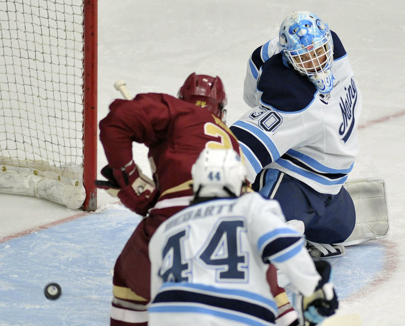 Bill Arnold of Boston College gets a shot past UMaine goalie Dan Sullivan, scoring a power-play goal to put BC ahead 1-0. Maine rallied and eventually got the win in overtime. The teams meet again today in Orono at 4 p.m.