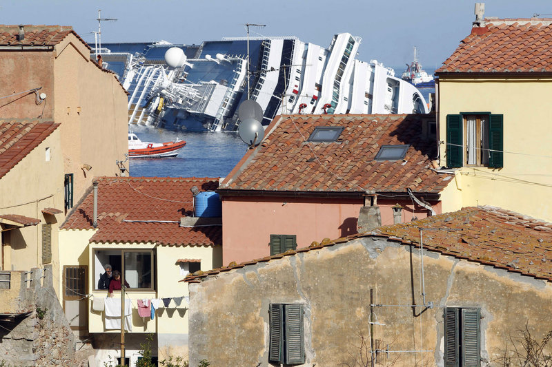 The grounded cruise ship Costa Concordia looms off the Tuscan island of Giglio, Italy, on Saturday.