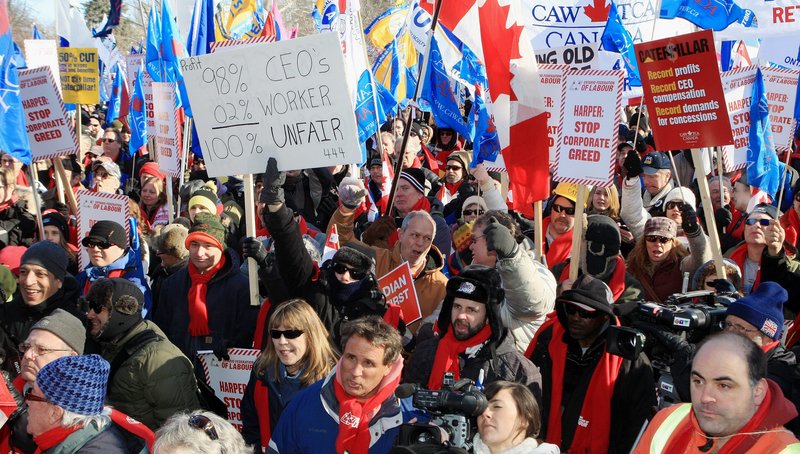 People gather at a rally dubbed a "London Day of Action Against Corporate Greed" in London, Ontario, Canada, on Saturday. The workers were locked out after they rejected a contract offer that would have cut wages in half and slashed benefits at a time Caterpillar is reporting record profits.
