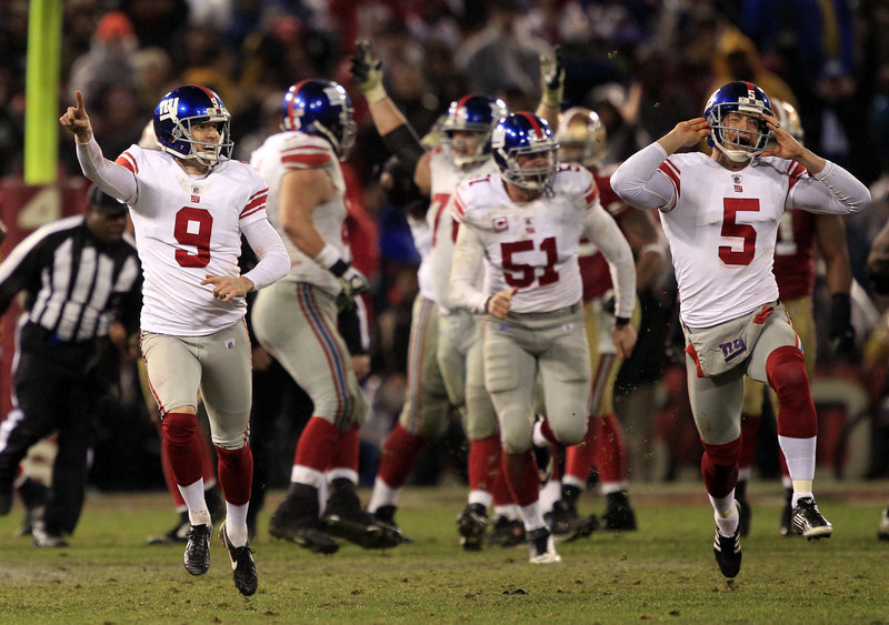 Lawrence Tynes, left, celebrates after kicking his winning 31-yard field goal in overtime Sunday as the Giants topped the 49ers 20-17. Tynes’ holder, punter Steve Weatherford, right, is also relishing the moment. Four years ago, Tynes also kicked the Giants into the Super Bowl with an OT field goal in Green Bay.
