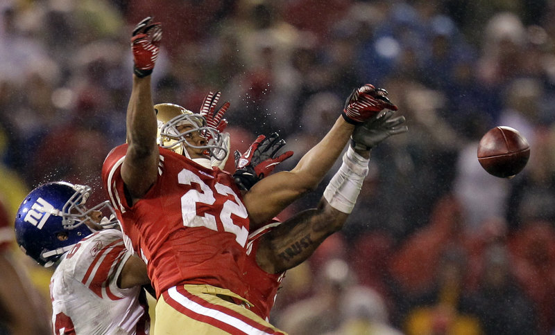 Carlos Rogers of the 49ers breaks up a pass for Victor Cruz of the Giants. Cruz finished with 10 catches for 142 yards.