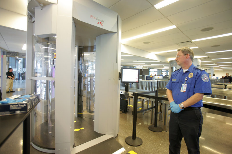 TSA employee Dale Tucker views one of the new passenger screening devices at the Portland International Jetport. The scanners screen for metal and nonmetallic items using electromagnetic waves. The software displays the suspect items on a generic body outline, below, rather than a passenger-specific image.