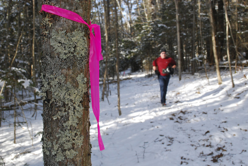 Volunteers from the Acadia Trail Runners mark trees every 10 meters along the course to prevent racers from getting lost.