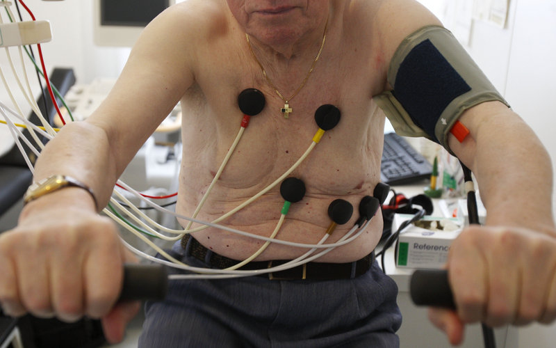 A man sits on an ergometer during an electrocardiogram test in a doctor’s office. Some of the nuts-and-bolts tests administered during checkups and non-emergency visits, which sometimes do more harm than good, are being deemed overused and unnecessary.