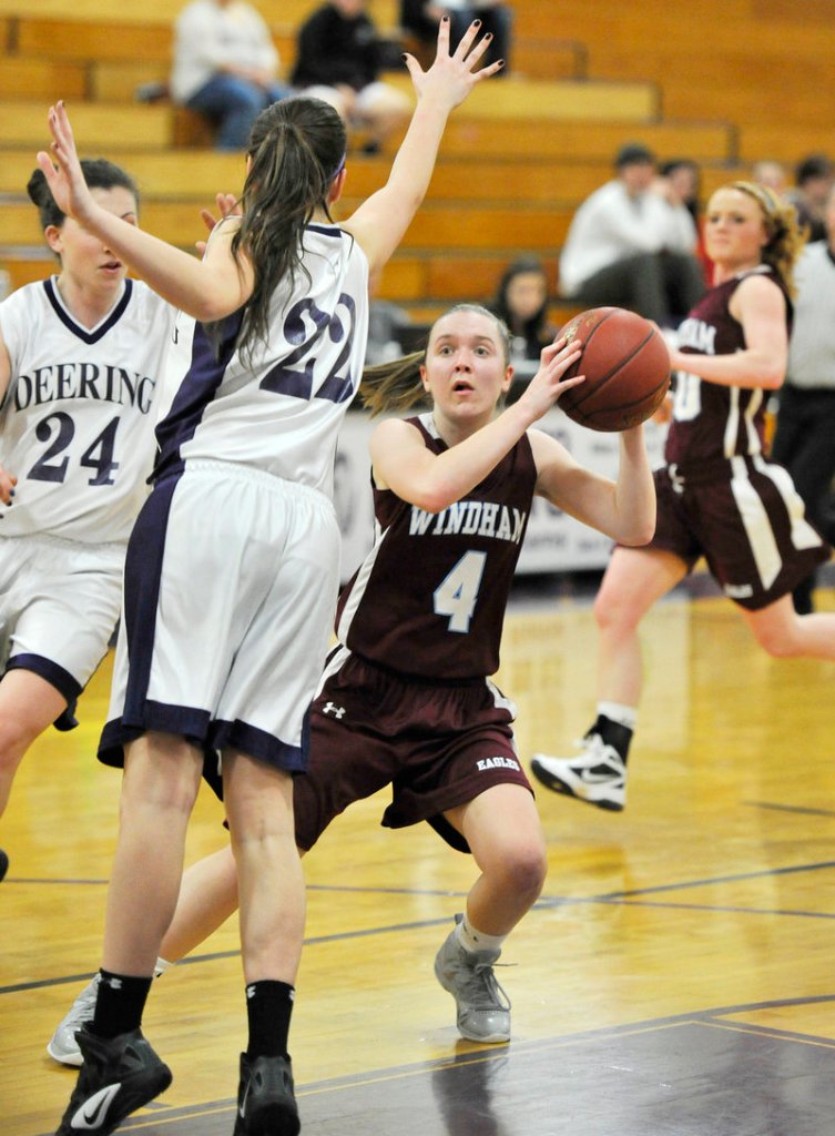 Meghan Gribbin of Windham tries to get off a shot while guarded by Chelsea Saucier during Deering’s 41-32 victory Tuesday night.