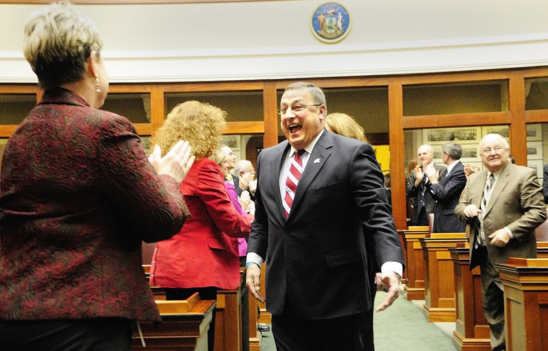 Gov. Paul LePage greets Rep. Joyce Maker, R-Calais, as he walks down the aisle in the State House to give his first State of the State address on Tuesday evening in Augusta.