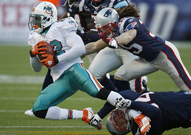 Ross Ventrone, at right, had his first career tackle for the New England Patriots during a Dec. 24 game against the Miami Dolphins, emerging from his defensive back position to bring down Reggie Bush.