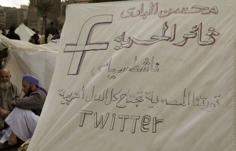 Protesters in Cairo last year during Egypt’s uprising made reference on their protest signs to Facebook and Twitter, showing the significance of the sites in protest communications.