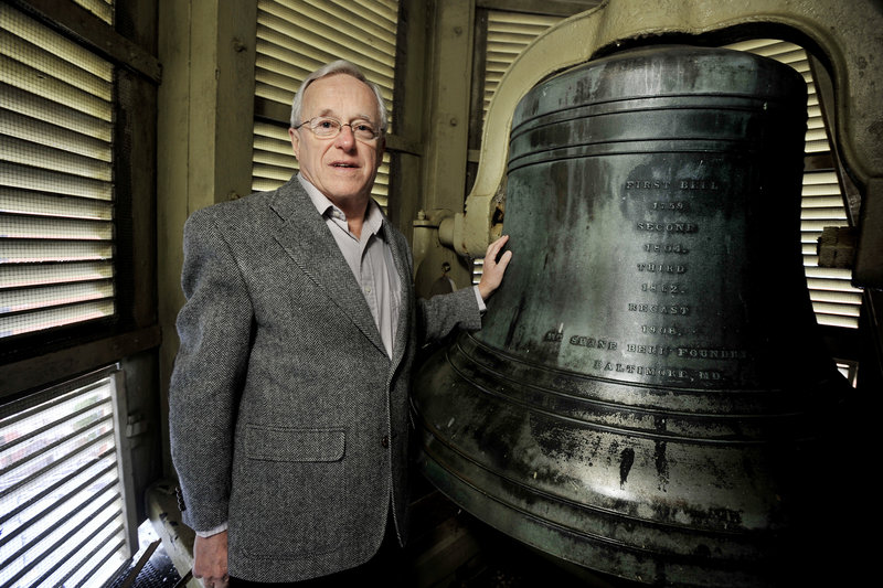 Stephen Jenks, president of the board of trustees of Portland’s First Parish Church, stands in the steeple with the church’s bell, which is its third.