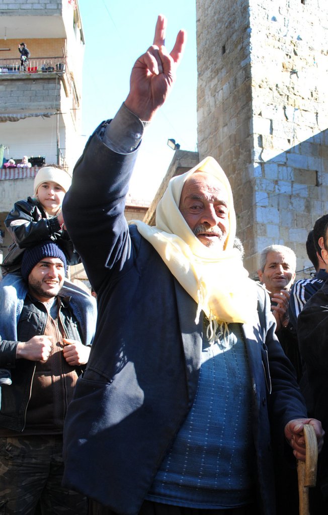 An anti-Syrian regime protester flashes a victory sign during a demonstration in Zabadani on Friday.
