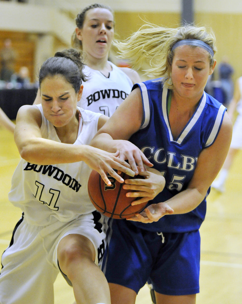 Jill Henrikson, left, of Bowdoin battles with Colby’s Kelly Potvin in Saturday’s game at Brunswick. The Polar Bears had a big second half to produce a 64-52 win.