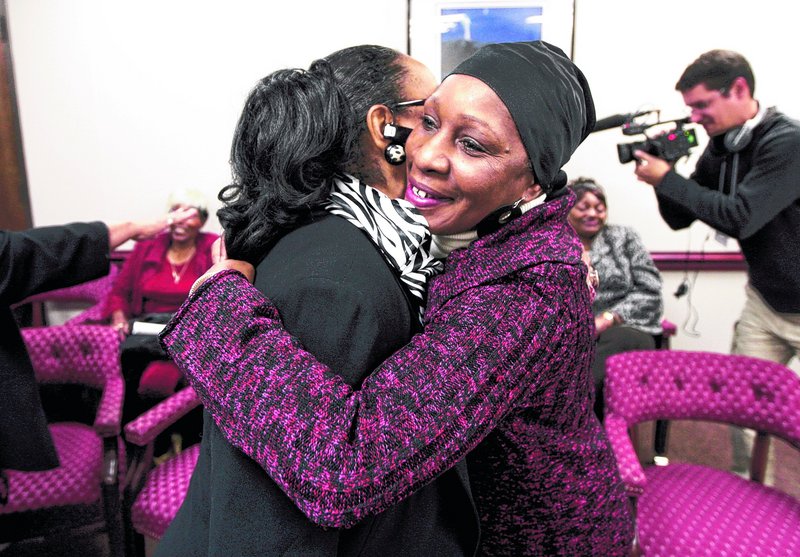 Elaine Riddick, 57, right, hugs Australia Clay after the Eugenics Compensation Task Force voted Jan. 10 to recommend paying $50,000 each to people like Riddick, who was sterilized at 14 after having given birth to a child following a rape.