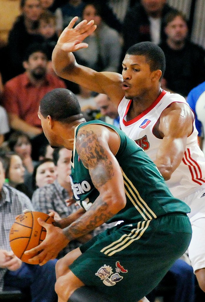 Morris Almond of the Red Claws defends against Reno’s Andre Emmett, who scored 31 points to lead the Bighorns to a 105-102 win.