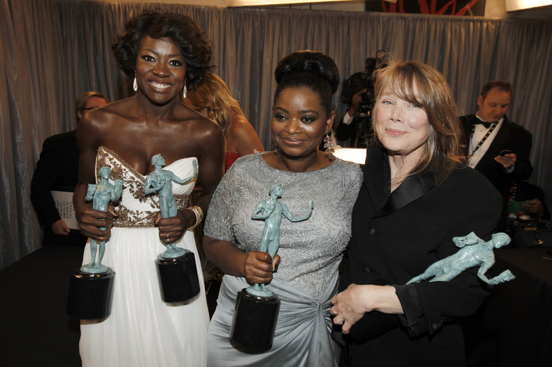 Viola Davis, left, Octavia Spencer, center, and Sissy Spacek gather backstage after accepting the award for overall cast performance for “The Help” at the Screen Actors Guild Awards on Sunday. Davis also won as best actress.