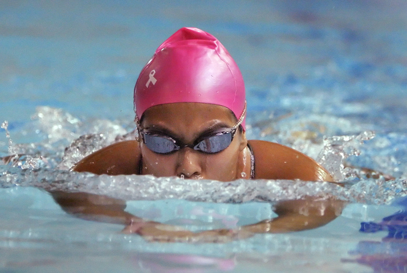 Blanca Monsen of Gorham wins the 200-yard individual medley Wednesday night with a time of 2:44.99 during a meet with Greely in Cumberland. Swimmers from several teams are wearing pink caps to raise awareness of breast cancer.
