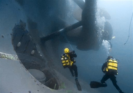 In this photo released by the Italian Fire Brigade, firemen scuba divers check one of the propellers of the luxury cruise ship Costa Concordia that run ashore off the Tuscany island of Isola del Giglio, Italy. (AP Photo/Vigili del Fuoco)