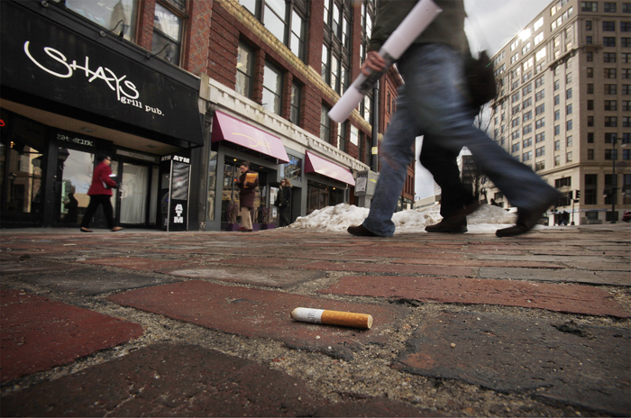A cigarette butt lies in Monument Square today. Beginning March 7, Portland smokers face a $100 fine for discarding cigarette butts on public property.