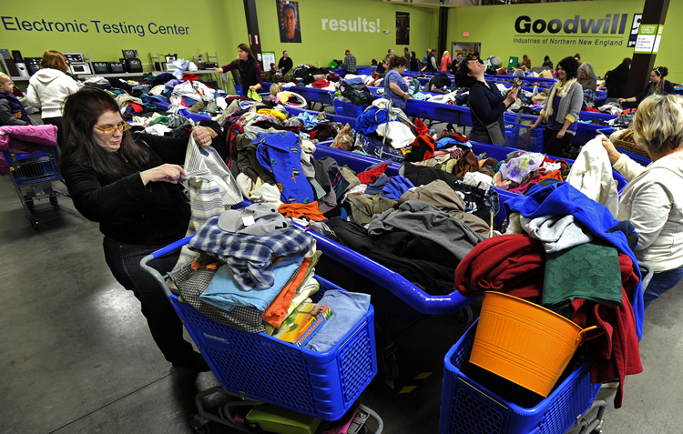 Julie Young of York Harbor browses through clothes at the opening of Goodwill's Buy the Pound Warehouse Outlet today in the Gorham Industrial Park.