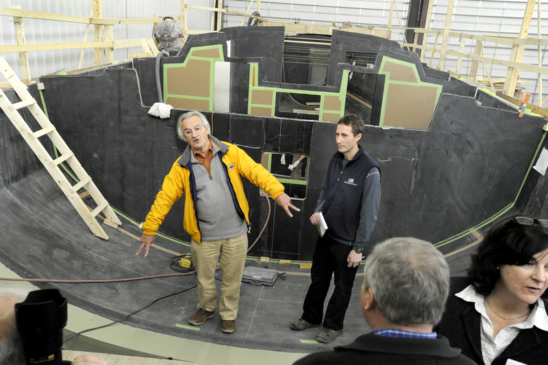 Stanley Paris, left, and Lyman-Morse project manager Lance Buchanan stand inside the hull mold of the Kiwi Spirit, which Paris plans to sail around the globe next year.