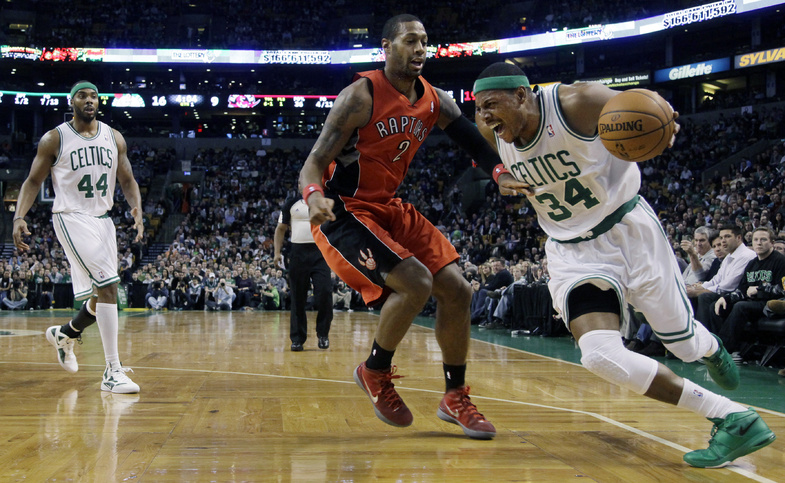 Boston's Paul Pierce drives the baseline around Toronto Raptors forward James Johnson Wednesday night in Boston. The Celtics won, 100-64.