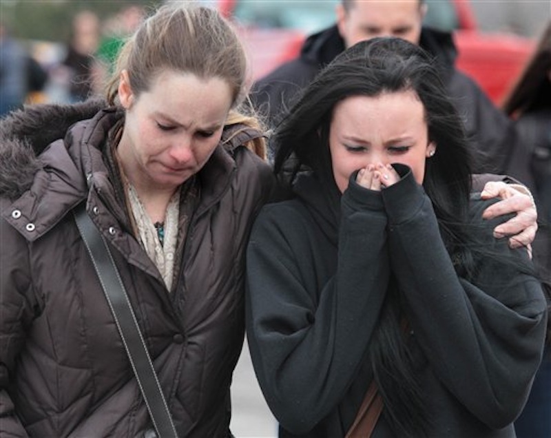 A distraught Ava Polaski, a sophomore, leaves school grounds with her mother Misty Polaski following a shooting in Chardon, Ohio on Monday, Feb. 27, 2012. A teenager described as a bullied outcast at Chardon High School opened fire in the cafeteria Monday morning, killing three students and wounding two others before being caught a short distance away. (AP Photo/The Plain Dealer, Thomas Ondrey)