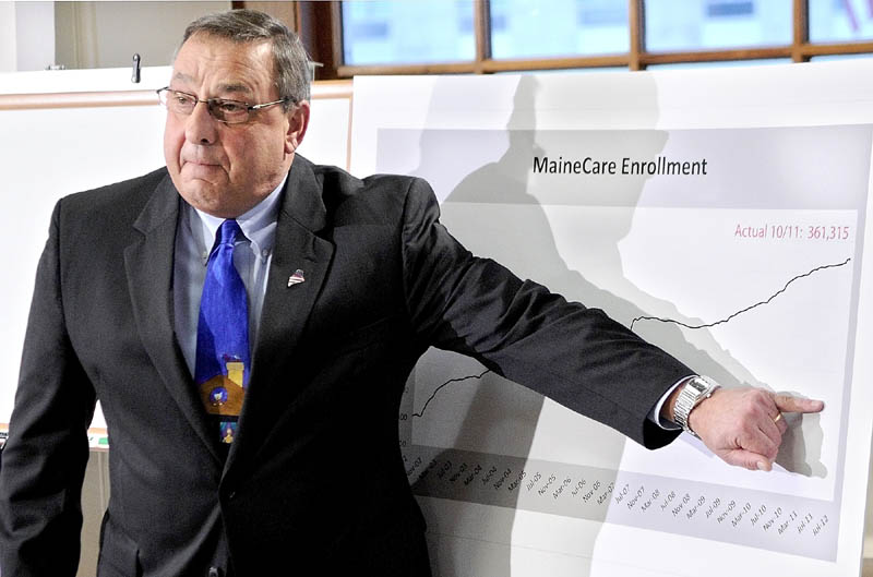 Gov. Paul LePage gestures at a graph during a news conference in December to announce proposed cuts to the MaineCare system. The graph shows the increasing number of residents who rely on MaineCare. The governor made clear in a news conference Monday that his proposal isn't just about money, but about policy too.