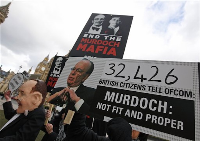 This Feb. 15 photo shows protesters holding banners outside the Palace of Westminster against Rupert Murdoch's ownership of British national newspapers, which are being investigated for allegations of phone hacking and payments to police officers. (AP Photo/Alastair Grant)