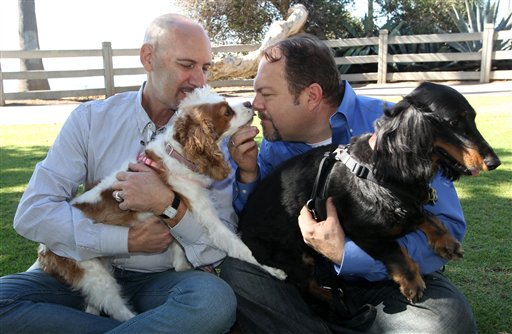 Steven May, left, holding his dog, Winnie, sitting with his attorney, David Pisarra and his dog Dudley in Santa Monica, Calif., recently. May, a pet consultant, hired Pisarra six years ago to handle his divorce.