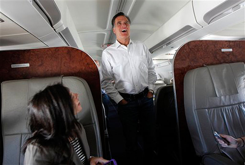 Republican presidential candidate, former Massachusetts Gov. Mitt Romney talks to reporters on his campaign plane en route from Tampa, Fla. to Minnesota on Wednesday, Feb. 1, 2012. (AP Photo/Gerald Herbert)