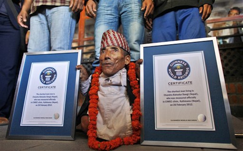 Nepal's Chandra Bahadur Dangi poses with his certificates after being declared the world's shortest living man and shortest man ever by the Guinness Book of Records at a ceremony in Katmandu, Nepal, Sunday, Feb. 26, 2012. The 72-year-old man was measured at just 21.5 inches (54.6 centimeters) tall has been declared the shortest person to be recorded by the Guinness World Records snatching the title from Junrey Balawing of the Philippines, who is 23.5 inches (60 centimeters) tall. (AP Photo/Niranjan Shrestha)