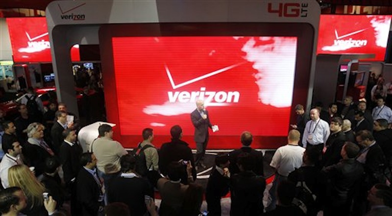 In this Jan. 6 photo, attendees check out the unveiling of 4G devices at the Verizon booth during the Consumer Electronics Show, in Las Vegas. Challenging Netflix, Verizon said Monday, Feb. 6, 2012, it will start a video streaming service later this year in cooperation with Redbox and its DVD rental kiosks. (AP Photo/Isaac Brekken)