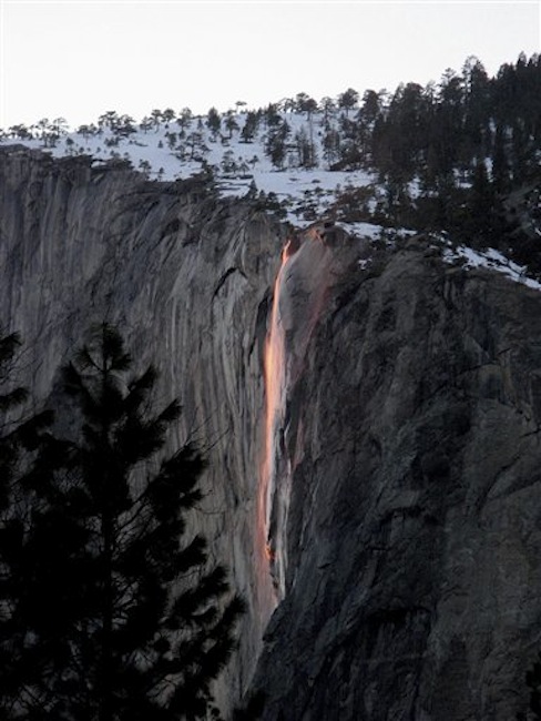 In this undated photo provided by the Scott Gediman of the Yosemite National Park Service, the firefall from Glacier Point is shown in Yosemite. A window of time just opened in Yosemite National Park when nature photographers wait, as if for an eclipse, until the moment when the sun and earth align to create a fleeting and spectacular phenomenon. (AP Handout Photo/Yosemite National Park Service, Bethany Gediman)