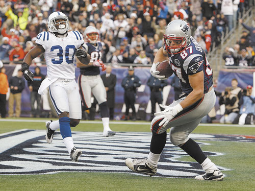Patriots tight end Rob Gronkowski,catches a touchdown pass as Colts strong safety David Caldwell is late to the play in a December game in Foxborough, Mass. Gronkowski may or may not be effective Sunday for the Patriots in the Super Bowl because of an ankle injury, but no matter. His influence in the NFL has been felt.