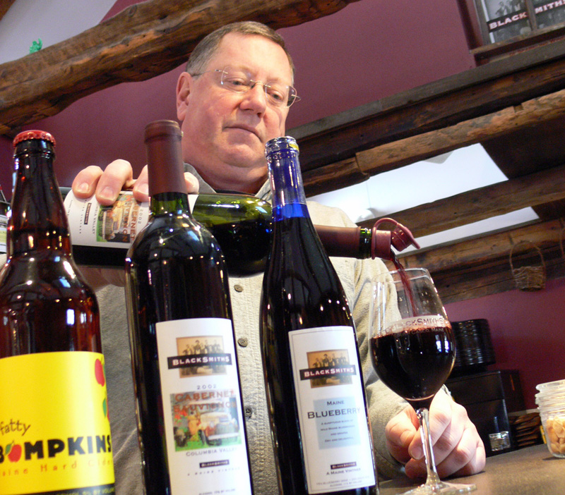 Steve Linne, founder of Blacksmiths Winery, pours a red wine at his tasting room in Casco.