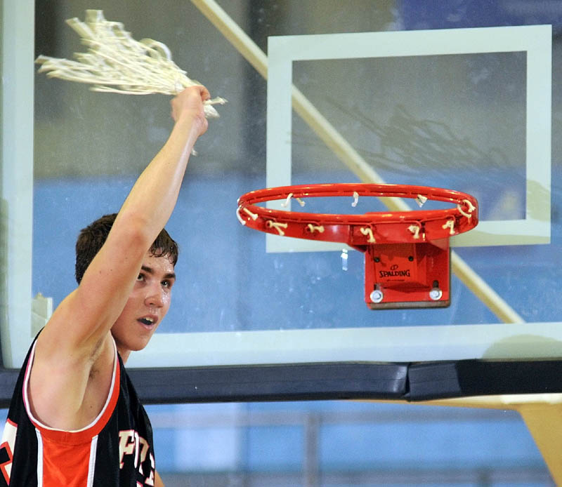 Forest Hills forward Evan Worster swings the net after cutting it down to celebrate the Tigers' victory over Hyde in the Western Class D championship game Saturday afternoon at the Augusta Civic Center. Worster scored 33 points as Forest Hills rallied for a 61-60 win.