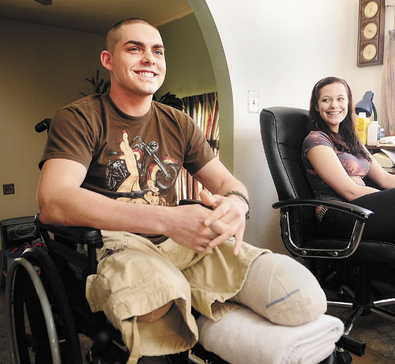 Jeremy Gilley, left, and girlfriend Rachael Turcotte, right, answer an interviewer’s questions at his parent’s home in Palermo. U.S. Representative Mike Michaud, of Maine, headlined a charity event for Gilley, 27, on Saturday. Gilley lost both his legs in December.
