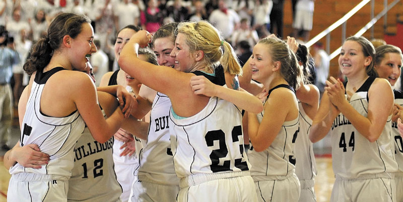 The Hall-Dale girls' basketball team celebrates after beating Waynflete, 43-36, to earn a spot in the Class C state championship game against Central.