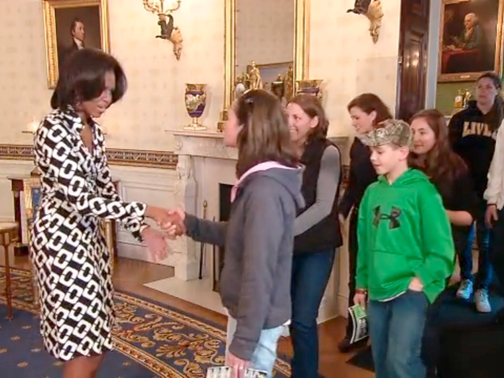 Michelle Obama exchanged high-fives with two Maine teens as their families toured the White House on Thursday.