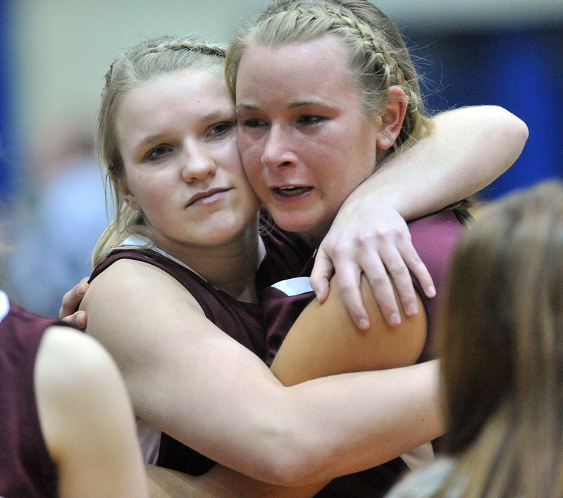 Nokomis teammates Taylor Quick, left, and Emilee Reynolds console each other after their team's loss to Presque Isle.