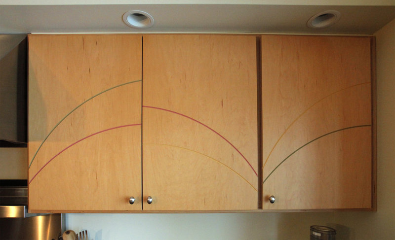 Kitchen cabinets have curved lines carved into them, continuing the wave theme.