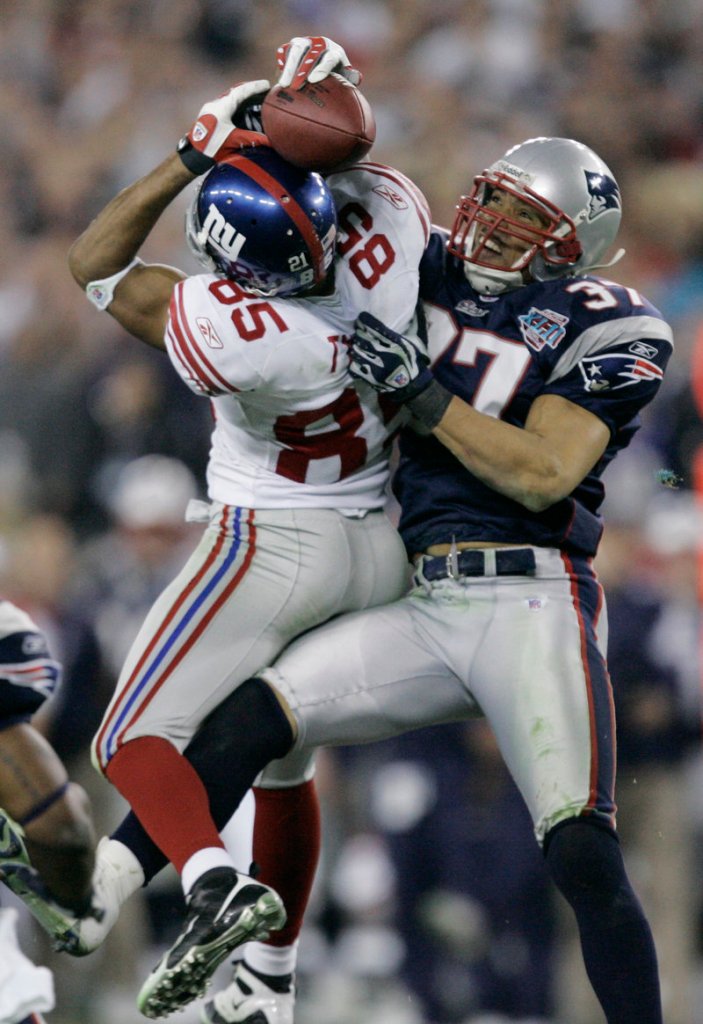 Giants receiver David Tyree catches a 32-yard pass in the clutches of Patriots safety Rodney Harrison in one of the defining plays of New York’s Super Bowl victory on Feb. 3, 2008.